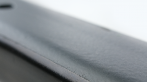 Selektiv mit Dickschichtschutz beschichtetes Chassis-Bauteil